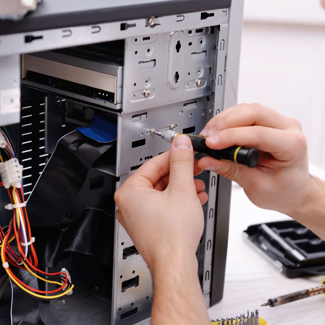 person working on computer hardware